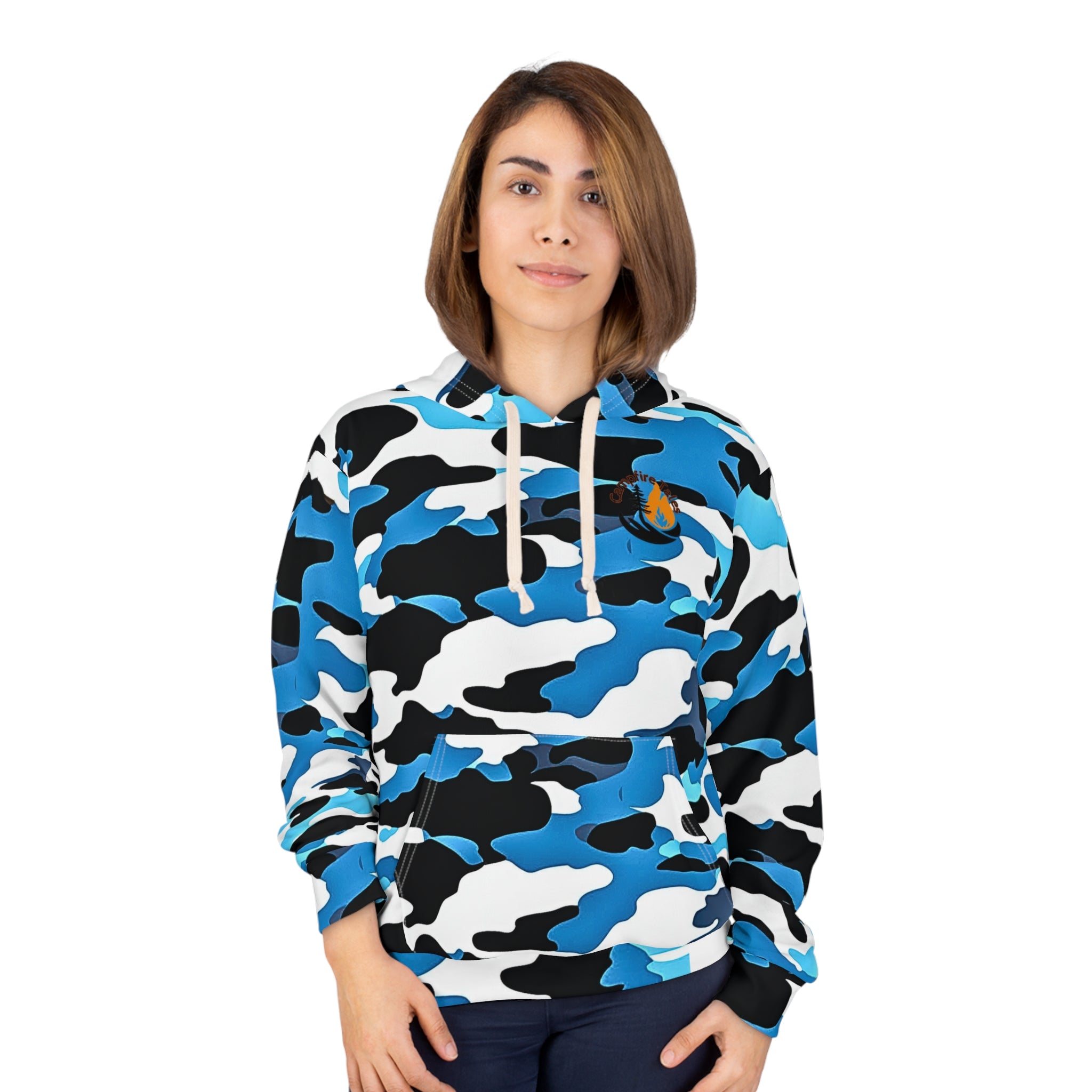 A person is standing and facing forward, wearing the Unisex Blue Camo Resilience Hoodie by Printify. This seamless polyester hoodie with a blue, black, and white camo pattern features white drawstrings and an emblem on the left chest. The backdrop is plain white.
